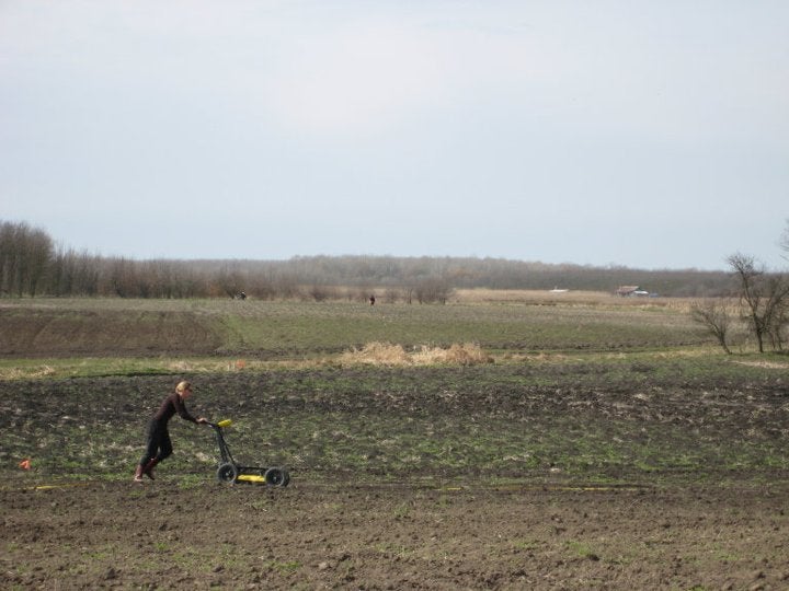 field in Hungary with person conducting geophysical survey